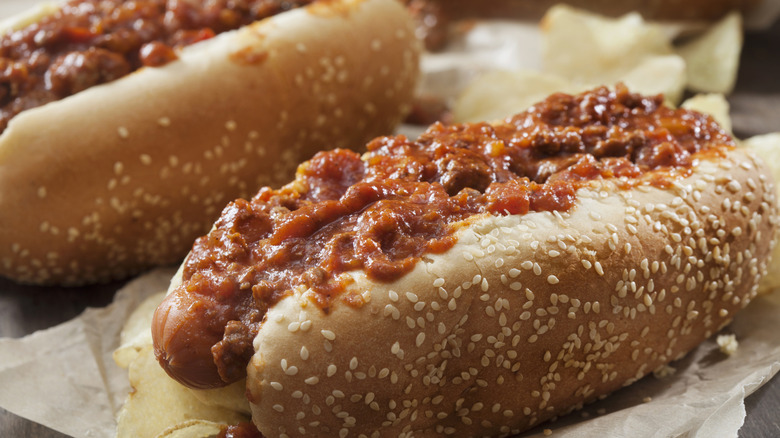 Two chili dogs topped with chili and cheese
