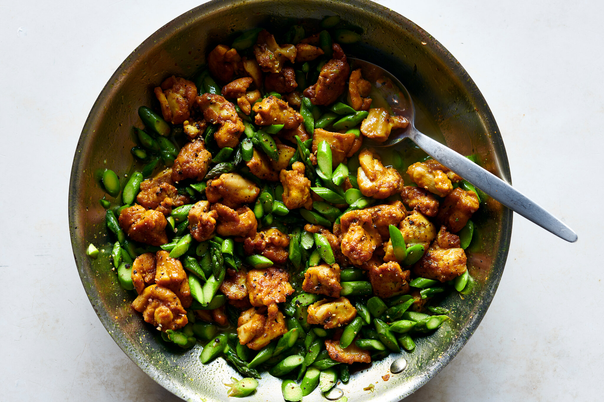 Turmeric Black Pepper Chicken and asparagus in a skillet